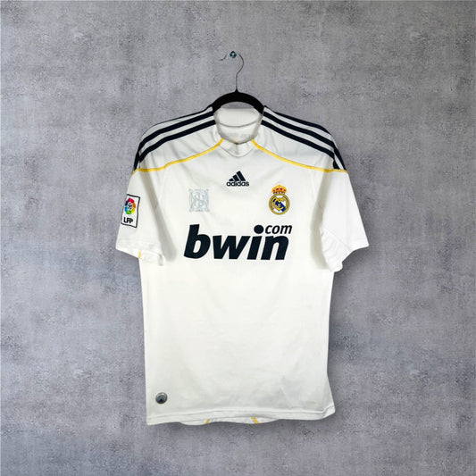 Vue de face du maillot blanc Real Madrid 2009/10 avec sponsor Bwin et liserés jaunes.