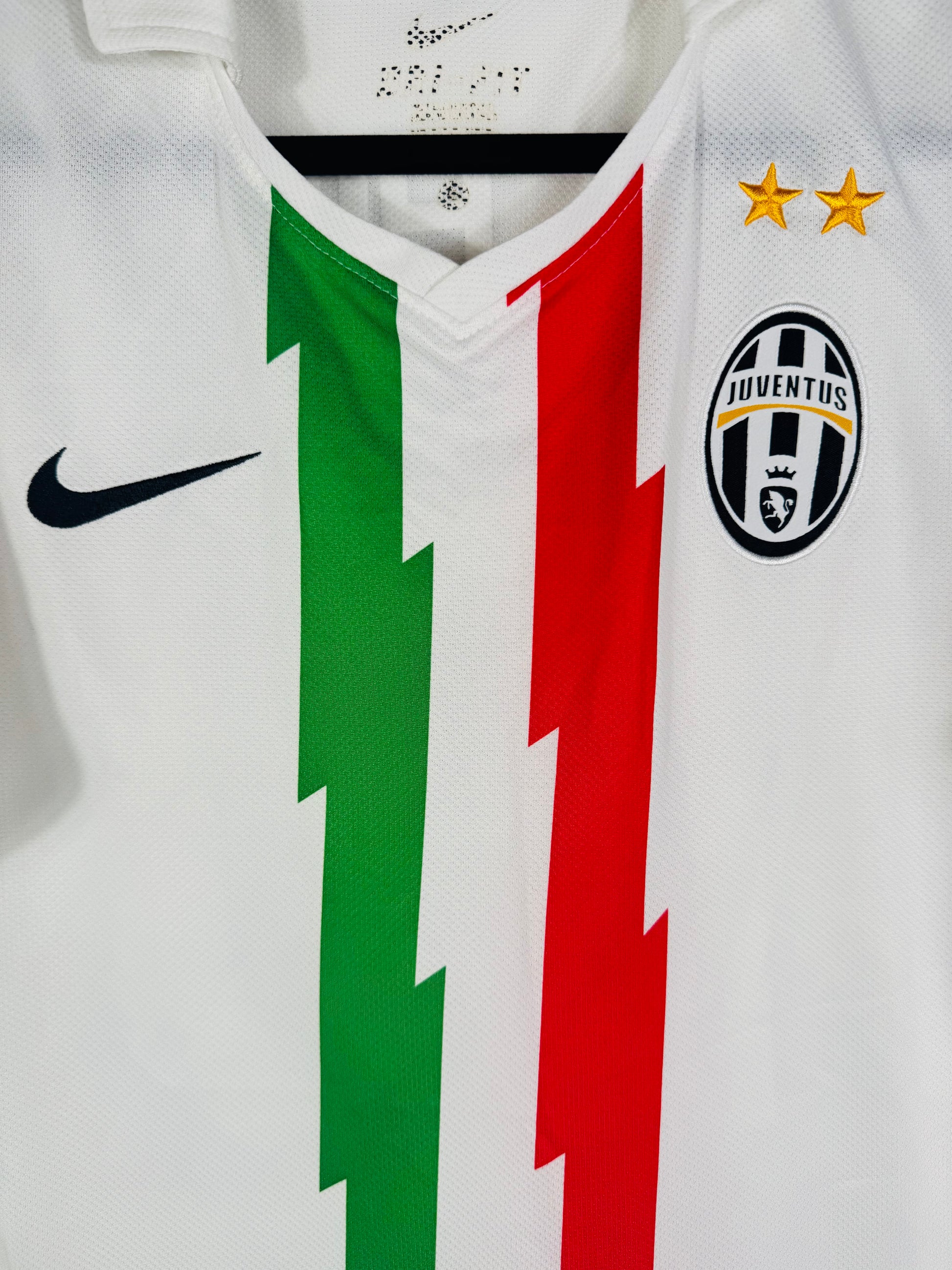 Gros plan sur l'écusson Juventus et le design en éclair du drapeau italien.