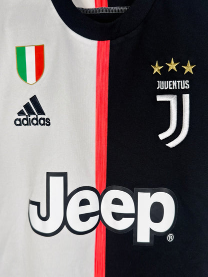 Gros plan sur le patch Scudetto (Champion d'Italie), le logo J et le logo Adidas.