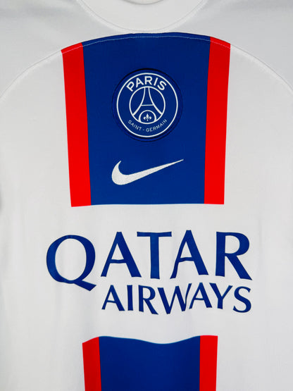 Gros plan sur l'écusson du Paris Saint-Germain et le logo Nike brodés sur la bande centrale.