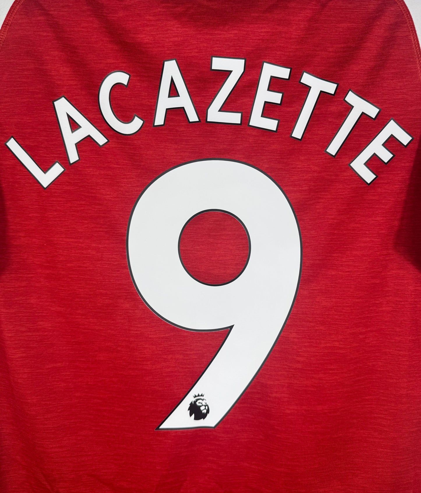 Zoom sur le nom LACAZETTE et le numéro 9 en typographie officielle Premier League.