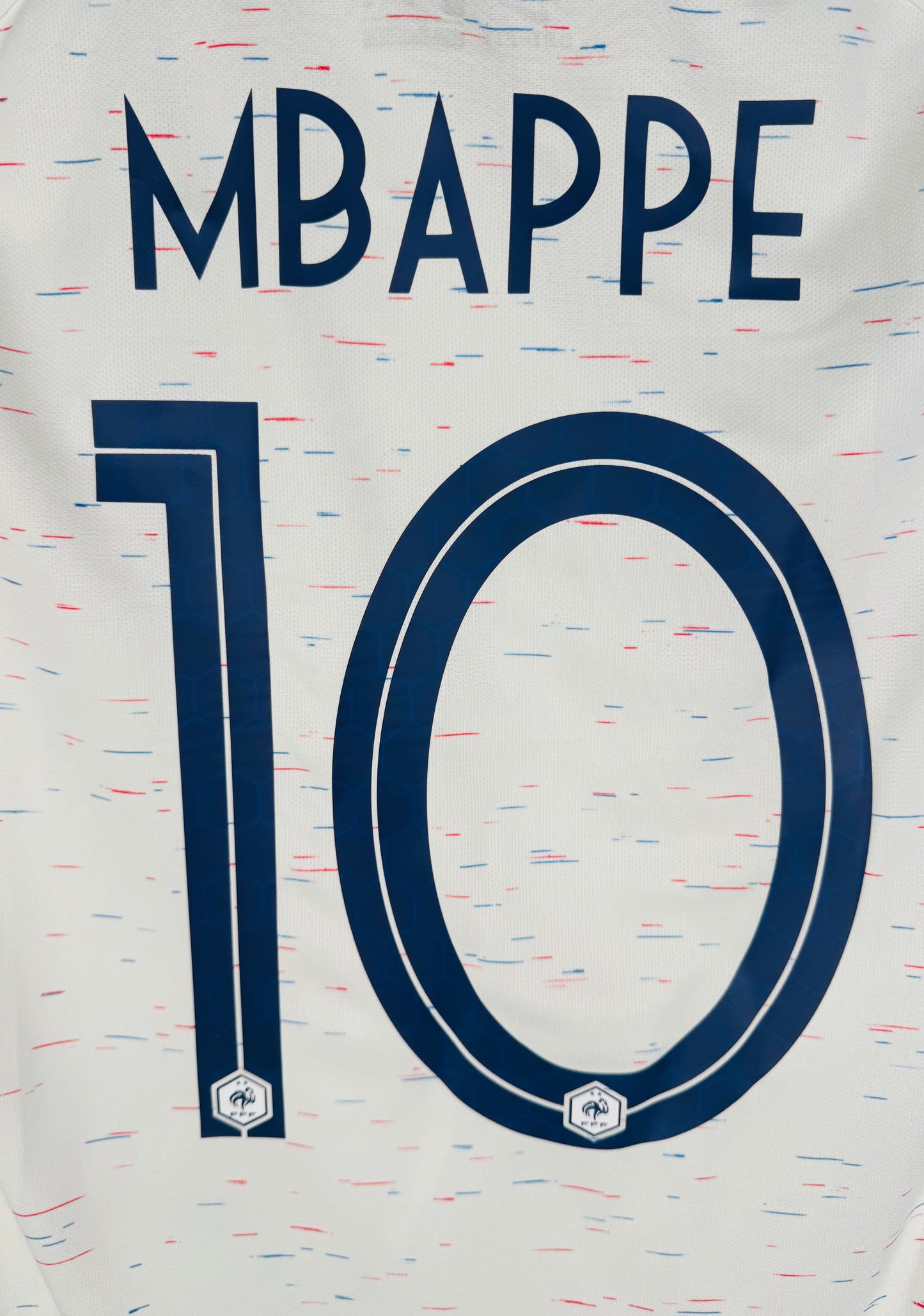 Zoom sur la typographie officielle hexagonale du numéro 10 et nom MBAPPE.