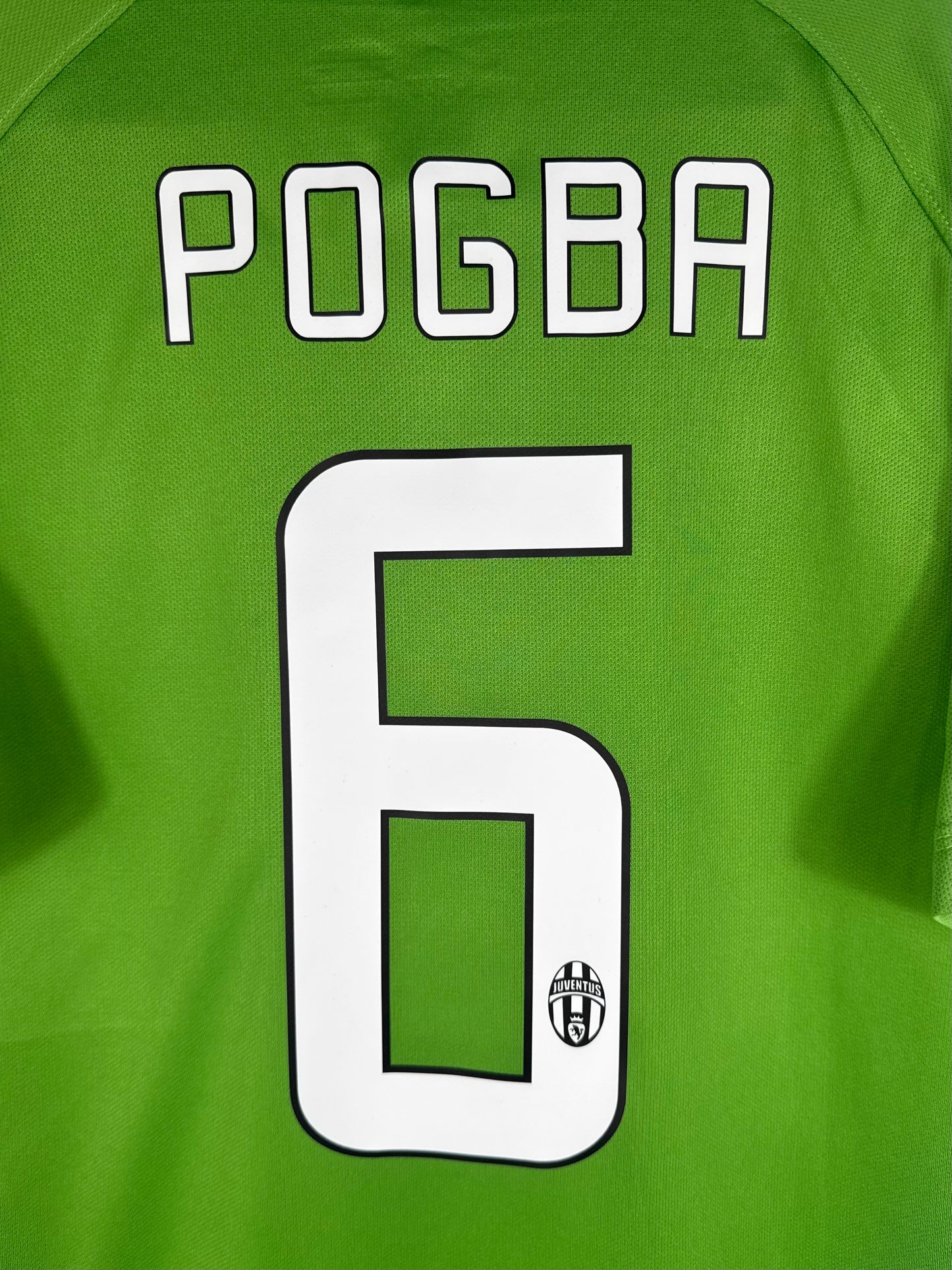 Zoom sur le nom POGBA et le numéro 6 blanc avec bordure noire.
