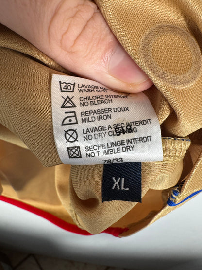 Étiquette d'authenticité Umbro certifiant le produit officiel OL taille XL.