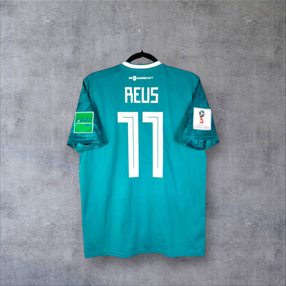 Dos du maillot Allemagne Extérieur 2018 vert émeraude avec flocage blanc REUS 11 et patch Coupe du Monde Russie.