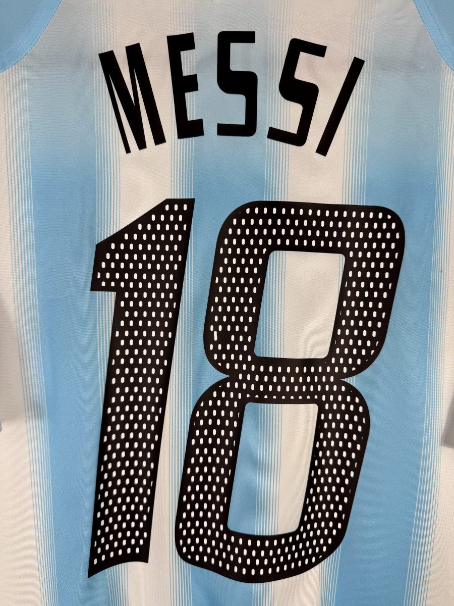 Gros plan du flocage MESSI N°18 du maillot Argentine 2004-2005, police adidas à pastilles blanches en parfait état