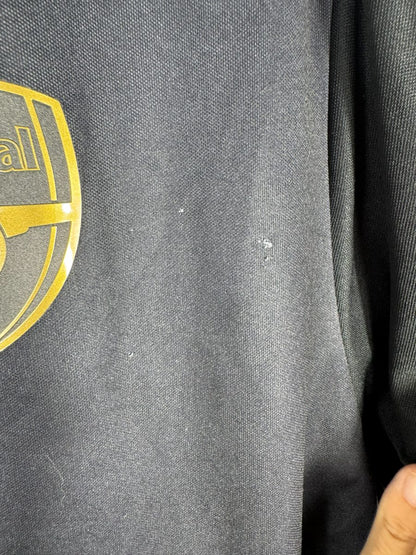 Défaut du maillot Arsenal 2015-2016 third : micro-marques blanches sur le tissu noir sous l'écusson