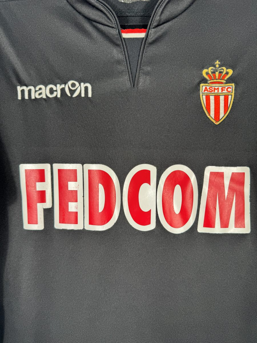 Détail du blason ASM FC brodé, du logo Macron et du sponsor Fedcom sur le maillot extérieur 2013-2014
