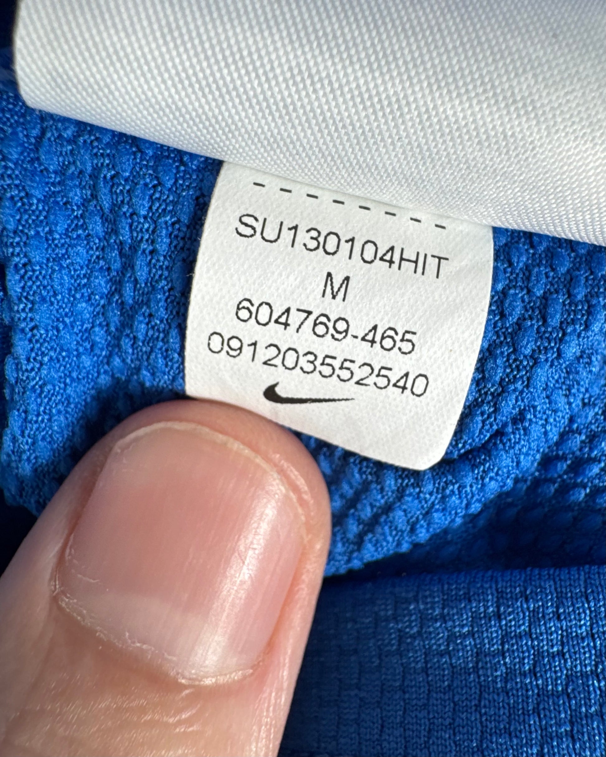 Étiquette d'authenticité avec code Nike 604769-465 prouvant l'originalité du maillot