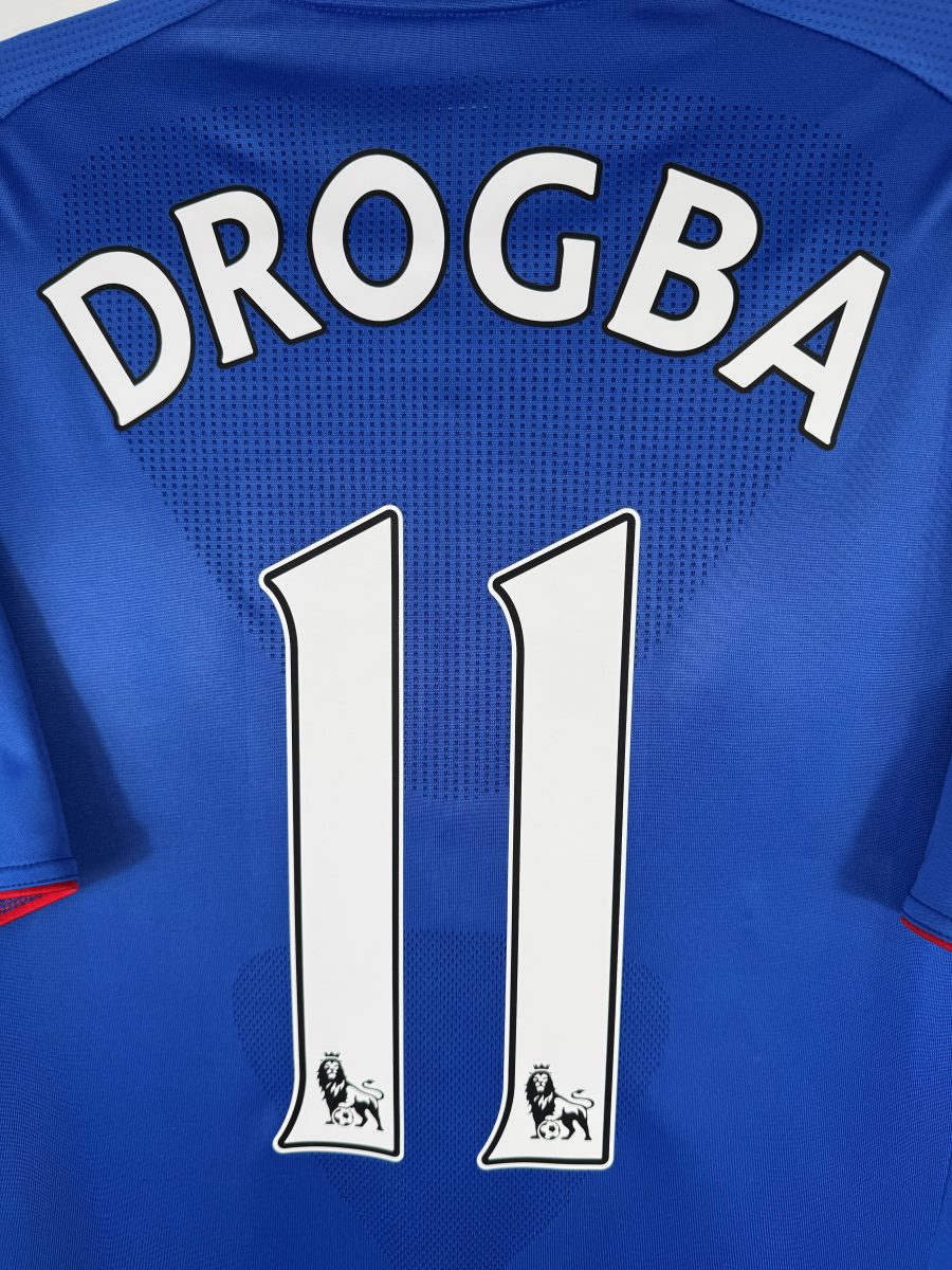 Détail flocage DROGBA 11 blanc avec lions Premier League, maillot Chelsea domicile 2010-2011