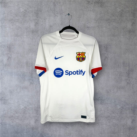 Vue de face du maillot blanc FC Barcelone 2023/24 hommage Cruyff avec logos bleus.