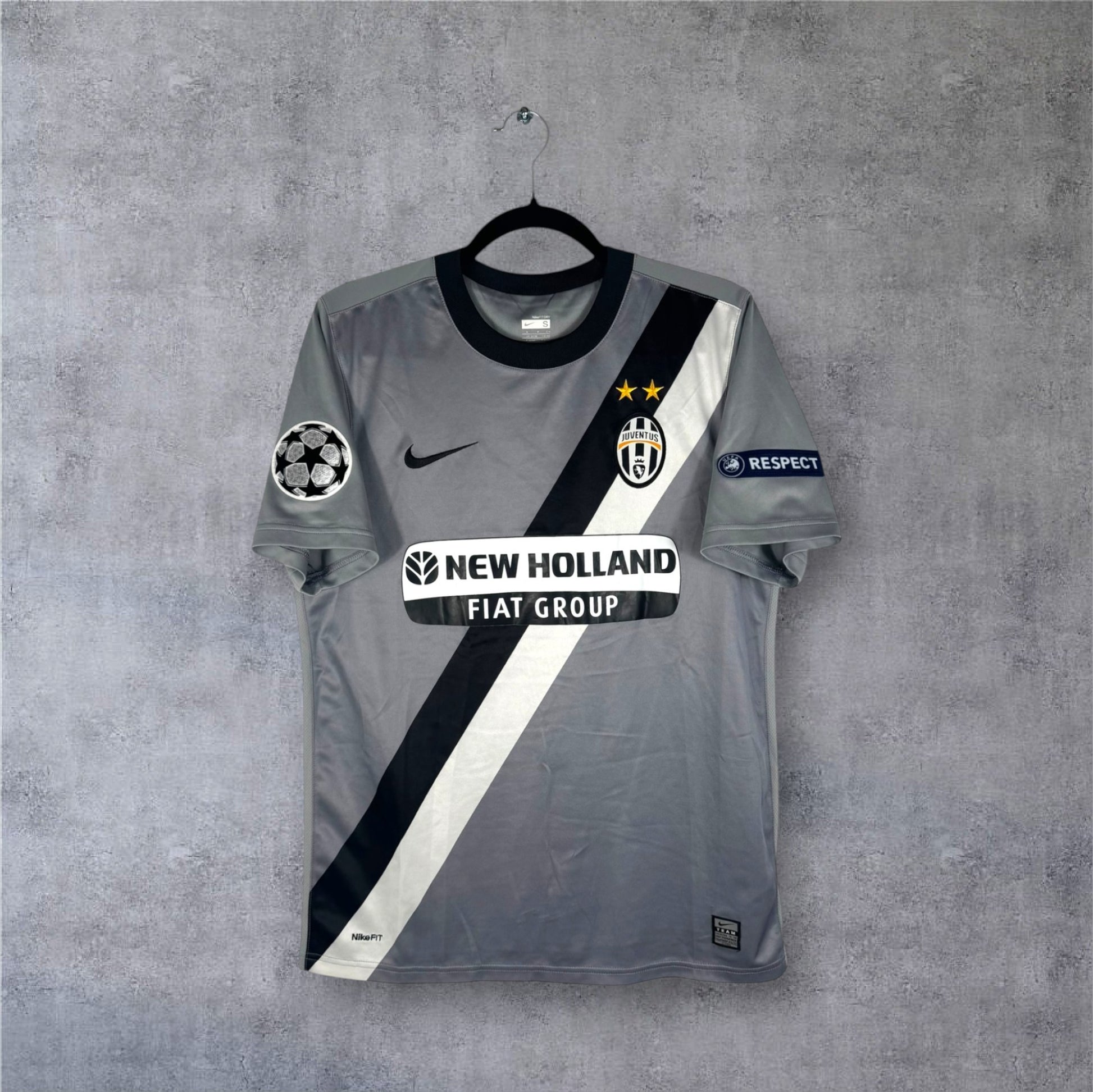 Vue de face du maillot Juventus Extérieur 2010 gris avec bande diagonale et sponsor New Holland.