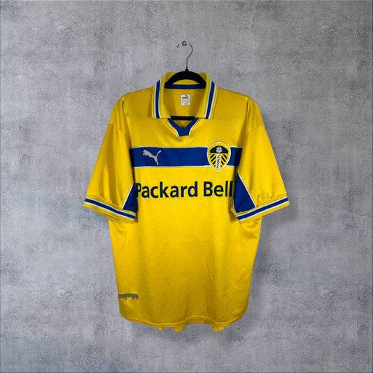 Maillot Leeds United third 1999-2000 jaune de face, bande bleue et sponsor Packard Bell