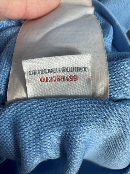 Étiquette Official Product 012789499, maillot Manchester City domicile 2012-2013 Umbro
