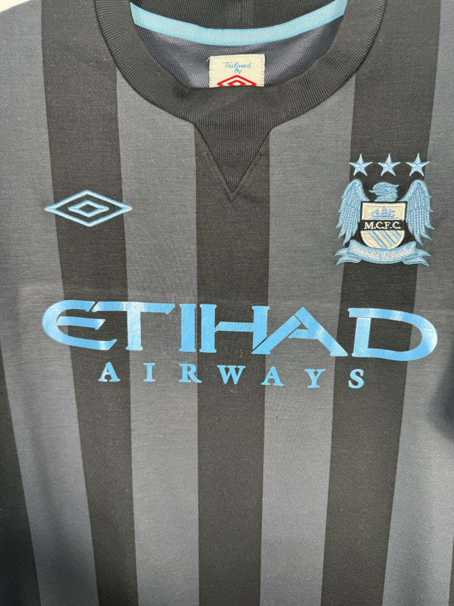 Écusson M.C.F.C. brodé bleu ciel avec trois étoiles et losange Umbro, maillot Manchester City third 2012-2013