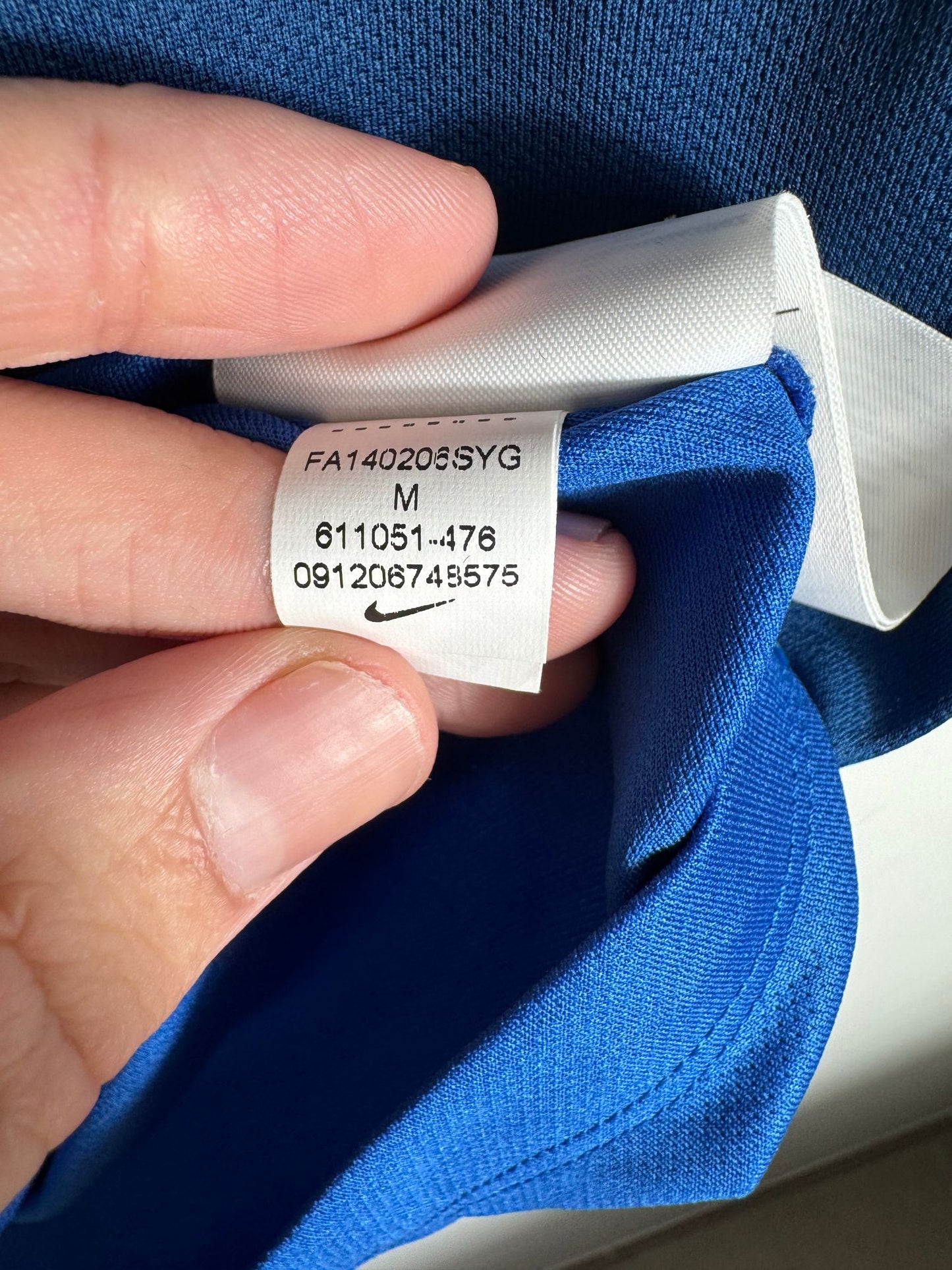Étiquette d'authenticité avec code Nike 611051-476 prouvant l'originalité du maillot