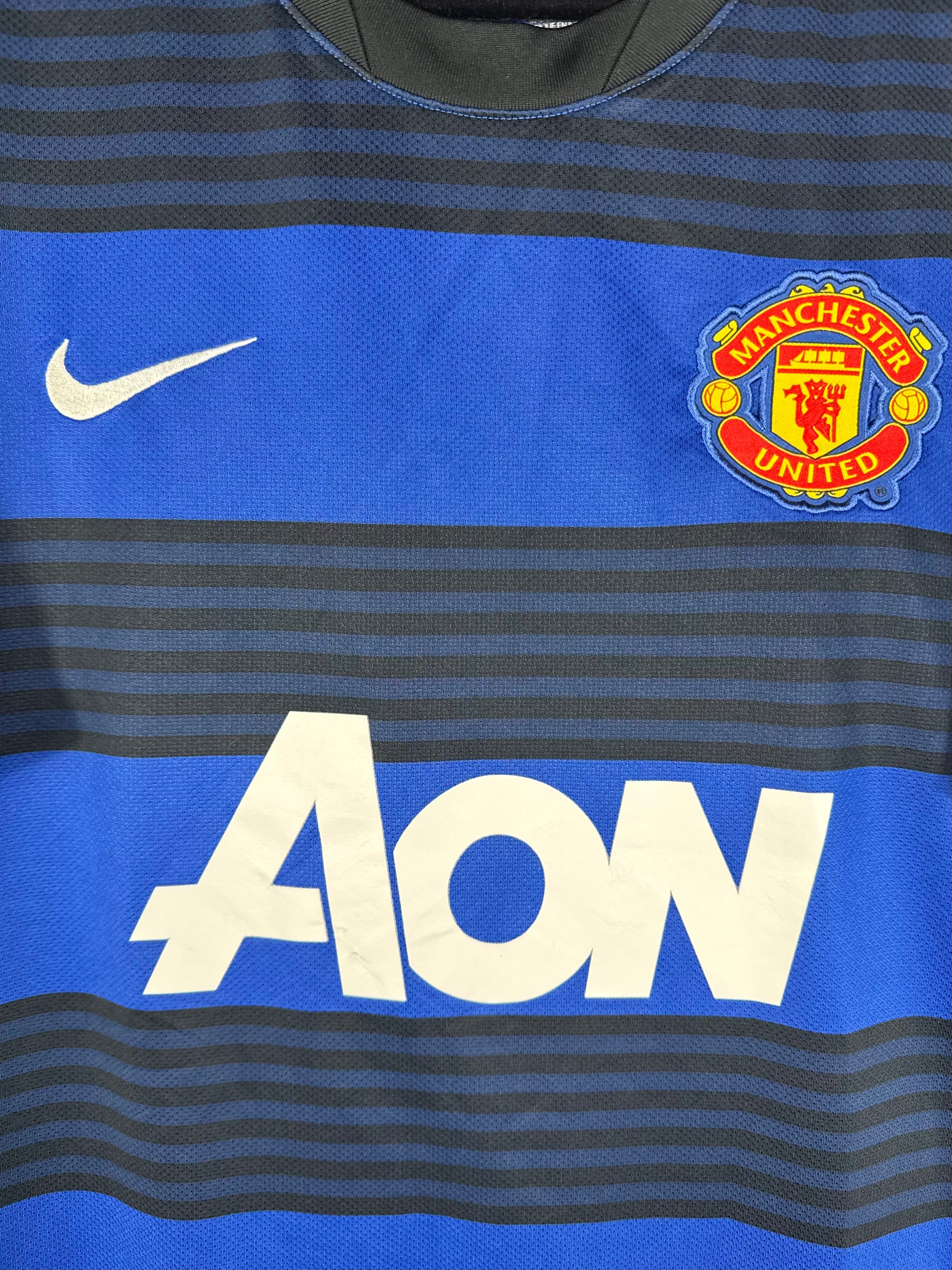 Détail de l'écusson de Manchester United et du logo Nike