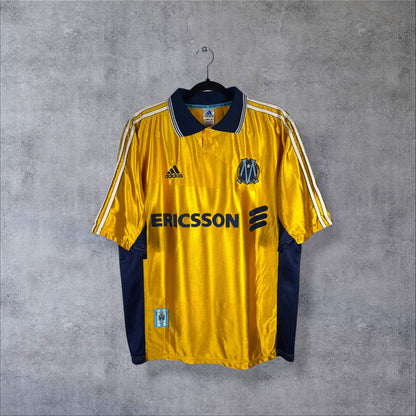 Face du maillot OM 1998-1999 third or du centenaire, adidas, sponsor Ericsson et écusson 1899-1999