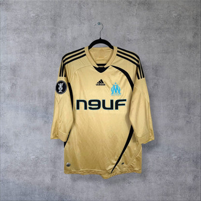 Maillot third OM 2008-2009 de face, doré à bandes noires, sponsor Neuf, manches longues