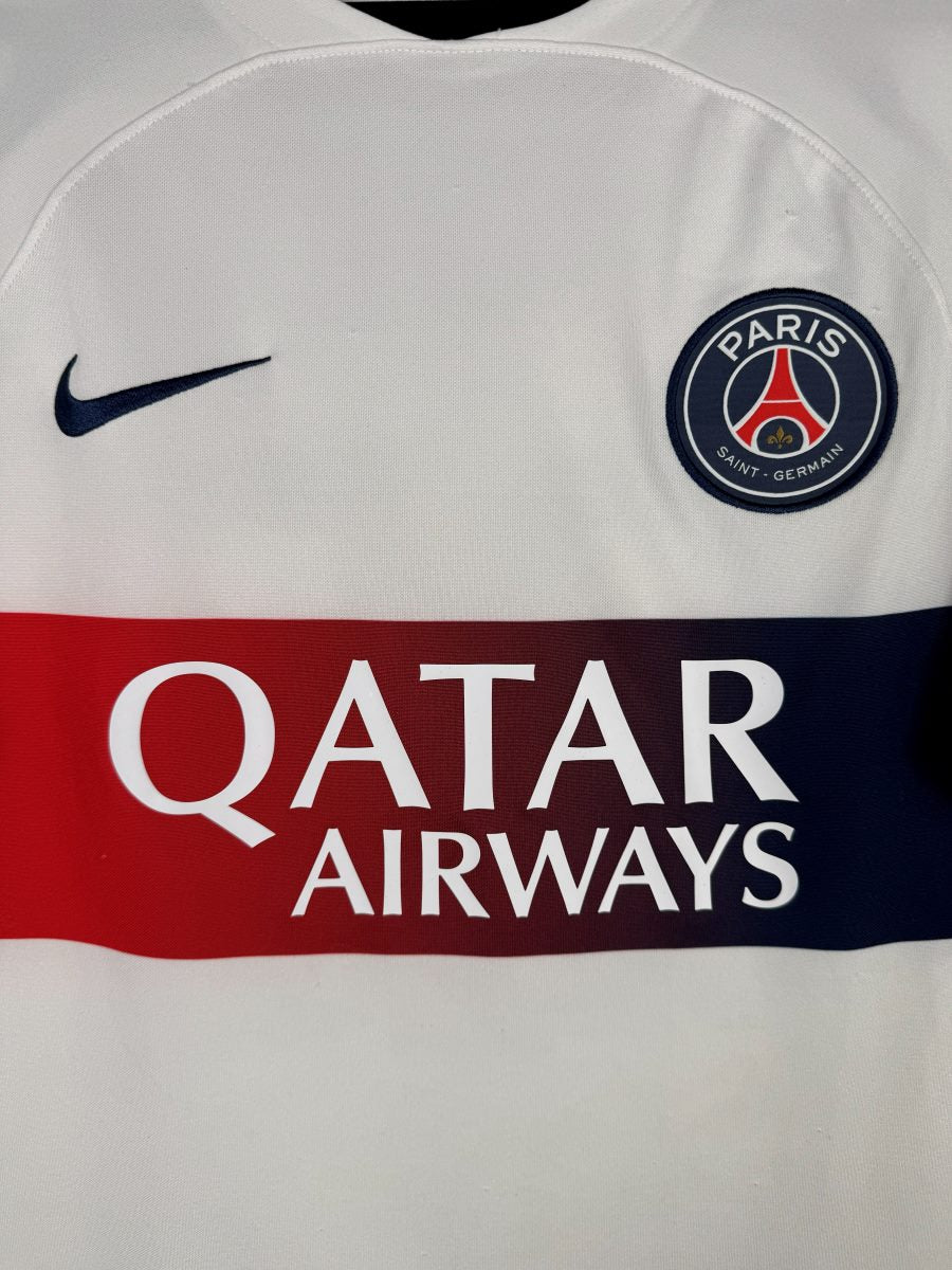 Détail écusson Paris Saint-Germain, swoosh Nike et sponsor Qatar Airways sur le maillot PSG 2023-2024 extérieur